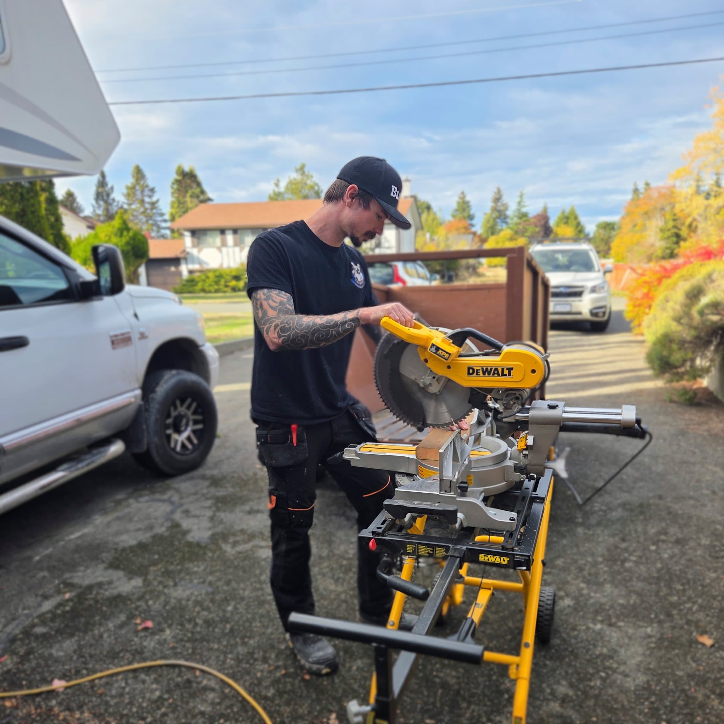 Caleb Wismer at a mitre saw on a job site
